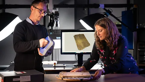 Cambridge University Library The new technology available has allowed scholars like Błażej Mikuła and Amélie Deblauwe to investigate manuscripts without damaging them (Credit: Cambridge University Library)