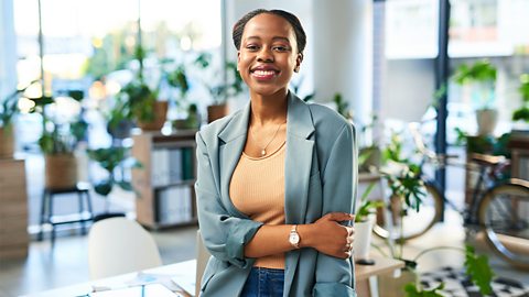 Smiling buinesswoman standing in an office