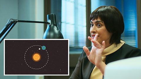 A NASA scientist explaining with the aid of a diagram how the Moon revolves around the Earth, and the Earth around the Sun