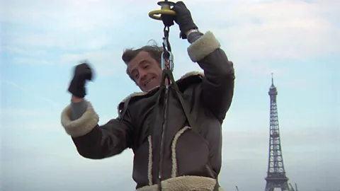 Alamy A shot of Jean-Paul Belmondo in the air in a harness (Credit: Alamy)