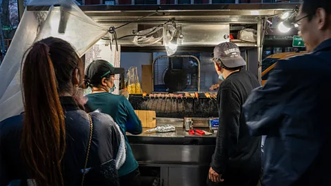 Ernesto Roman When the Grand Street Skewer Cart is open, the aroma of Xinjian-style meat skewers perfumes the block (Credit: Ernesto Roman)