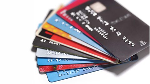 A pile of credit and debit cards on a white background