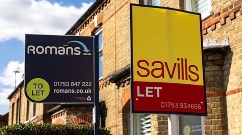 Two for let signs from different estate agencies in the front garden of a house in Slough, England.