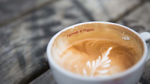 A fair trade and organic sign on the inside of a coffee cup representing the commitment to coffee bean suppliers.