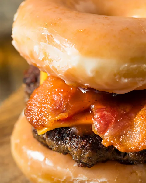 Alamy Cloake was excited by playful twists on food, like a cheeseburger with doughnuts instead of a bun (Credit: Alamy)
