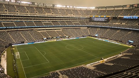 The MetLife stadium at night, with floodlights illuminating the pitch