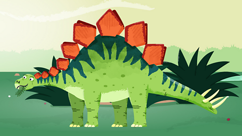 Image of a stegosaurus with red spikes and a dark and light green skin chewing some plants. It also has yellow spikes on its tail.  
