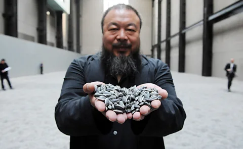Alamy In Ai Weiwei's 2010 Sunflower Seeds, the 100 million hand-painted porcelain seeds were inspired by posters of Chairman Mao (Credit: Alamy)
