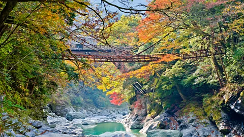 Getty Images Some guests at the former school venture to the nearby Kazura vine bridge (Credit: Getty Images)