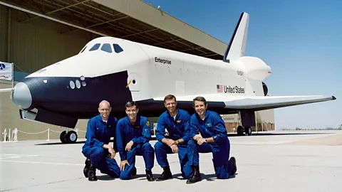 Nasa Four Nasa test pilots dressed in blue flight suits kneel in front of the space shuttle Enterprise at its unveiling in Palmdale, California in 1976 (Credit: Nasa)