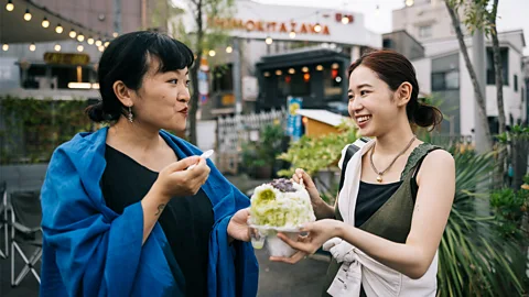 Getty Images Two women share a shaved ice (Credit: Getty Images)