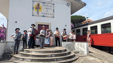 Katie Wright At Macinhata do Vouga, a generational folk band awaits to greet passengers (Credit: Katie Wright)