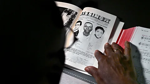 Getty Images A person looking at the missing poster of Michael W. Schwerner, James. E Chaney and Andrew Goodman (Credit: Getty Images)