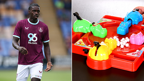Burnley defender Alex Tuanzebe walks in the midfield, a child plays hungry hungry hippos