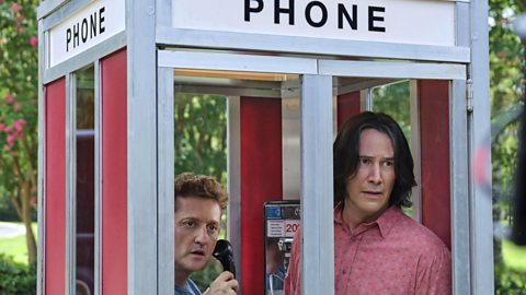 The characters Bill and Ted are inside a phone box in a scene from Bill and Ted Face the Music