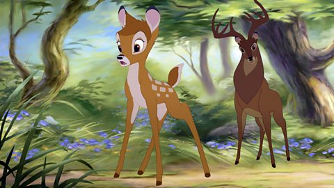 An animated scene from the Disney film Bambi II. Bambi and his father stand startled in the forest.