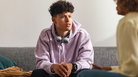Teenager talking to adult about their results.