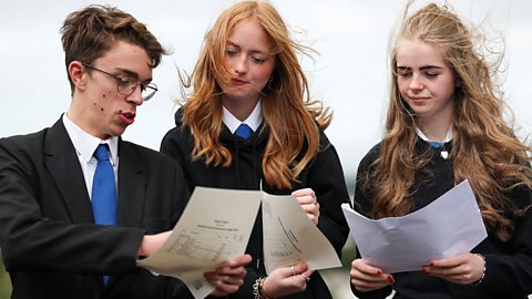 Students looking at their results slips.