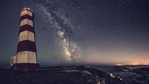 A panoramic view of the historic Sambro Island Lighthouse under the Milky Way