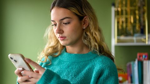 Teenager using phone.