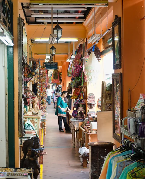 Alamy A shopping area in a five-foot way in Little India, Singapore. These arcaded tunnel through the ground floors of the city's shops and houses (Credit: Alamy)