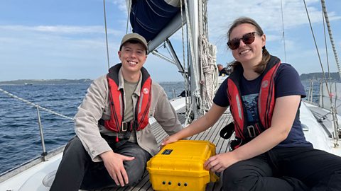 Gareth Elis and Rosie on a sailing boat with audio recording equipment