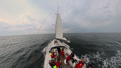 Gareth Elis,Rosie, and Dr. Julie Oswald at sea on a boat