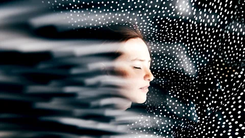 Getty Images Young woman surrounded by points of light (Credit: Getty Images)