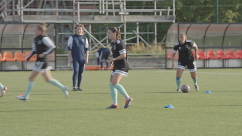 Nicole Koslova in a football training ground