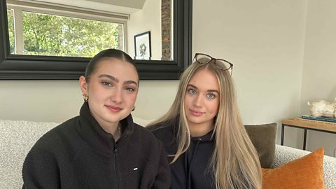 Evie and Gracie stare at the camera - they are talking about their use of Snapchat