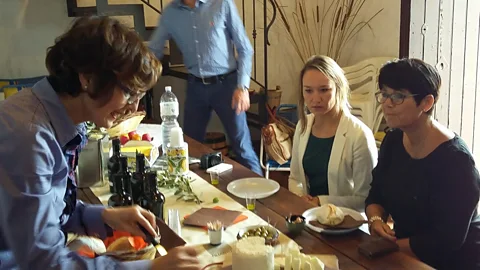 Adriana Calvaruso After a hard day of harvesting, the reward is a communal meal – and tasting of the new oil (Credit: Adriana Calvaruso)