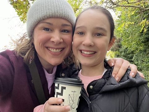 Rhiannon Carss with one of her daughters smiling 