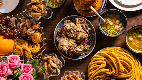 A table top view of an array of sweet and savoury dishes made for a traditional feast to celebrate Eid al-Fitr the end of Ramadan.