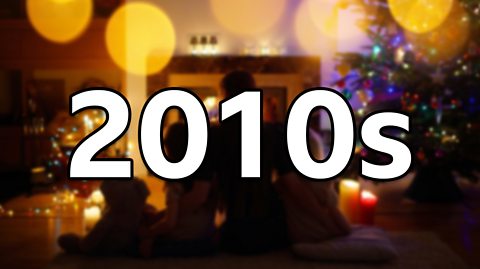 A 2015 image of a family sat in a warm, well-decorated living room, with '2010s' superimposed over the top