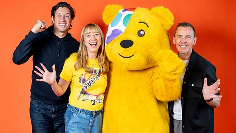 Vernon Kay, Sara Cox and Scott Mills smile and pose with Pudsey Bear