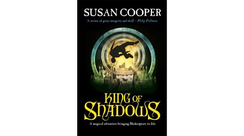 Book cover for King of Shadows by Susan Cooper: on a black background a figure spins around a golden vortex above Shakespeare's Globe theatre
