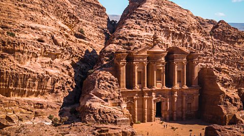A grand structure in Petra, which looks like a palace entrance, carved into the city's red rose rock