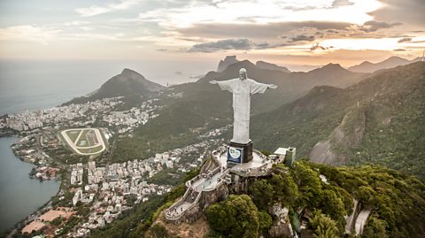 An aerial view of Christ the Redeemer, a 98-foot statue of Jesus Christ with his arms wide open, located at the top of the Corcovado Mountain, overlooking Rio de Janeiro, Brazil