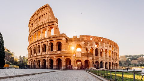  The Colosseum in Rome, Italy. The largest ancient amphitheatre ever built, the sunshine pours through one of the arches of the Colosseum 