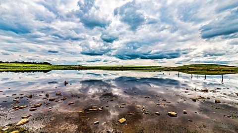 We see Dozmary Pool in a wide angle, with the clouds reflected in the water