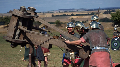 Roman soldiers firing a catapult. 