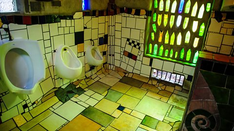 Hundertwasser public toilets in Kawakawa, New Zealand featuring colorful mosaic tiles, artistic design, and eco-friendly architecture