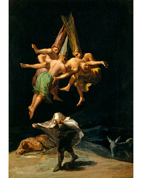 Alamy Witches' Flight by Francisco Goya (1798) portrays three floating figures in tall, conical hats carrying a man aloft (Credit: Alamy)