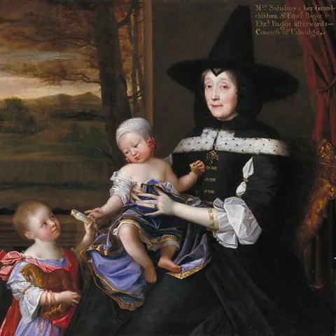 Getty Images In the 17th Century, tall black pointy hats were everywhere – shown here, Portrait of Mrs Salesbury with her Grandchildren (Credit: Getty Images)