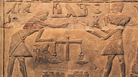 Egyptian heiroglyphics from 2340BC show men weighing gold