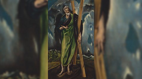 A painting of St Andrew, patron saint of Scotland, with a beard, bare feet and wearing green robes, leans against a wooden cross