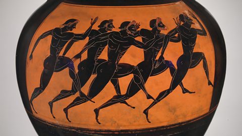 An old orange and black vase shows six men running in a race. They are drawn in black with simple lines, and the background is bright orange.