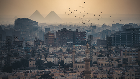 A photo of Cairo, with the pyramids of Giza in the background.