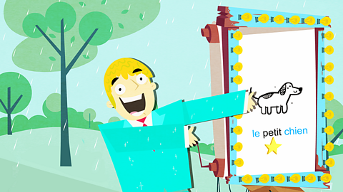 Burt Bessington points at his quiz display showing the adjective before a noun.