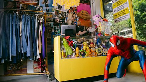 Interior of a Rogue store: yellow counter display stuffed with retro cuddly toys, life sized spiderman model, a rack of vintage jeans 